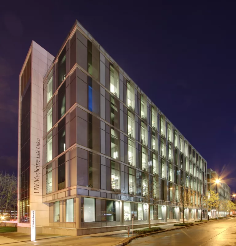 Exterior evening view of a seven-story laboratory facility at UW Medicine's Lake Union campus (Phase 2)