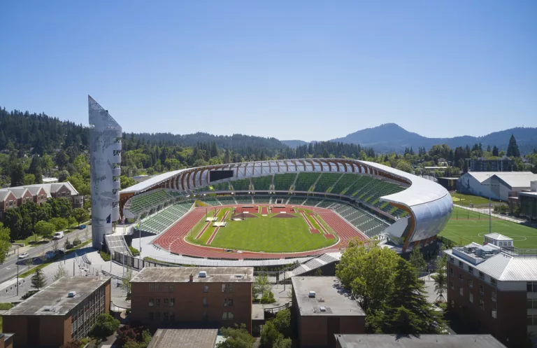 Daylight aerial view of the University of Oregon’s Hayward Stadium featuring a nine-story observation tower, track-and-field oval, and unique roof structure with a glulam-and-steel composite canopy
