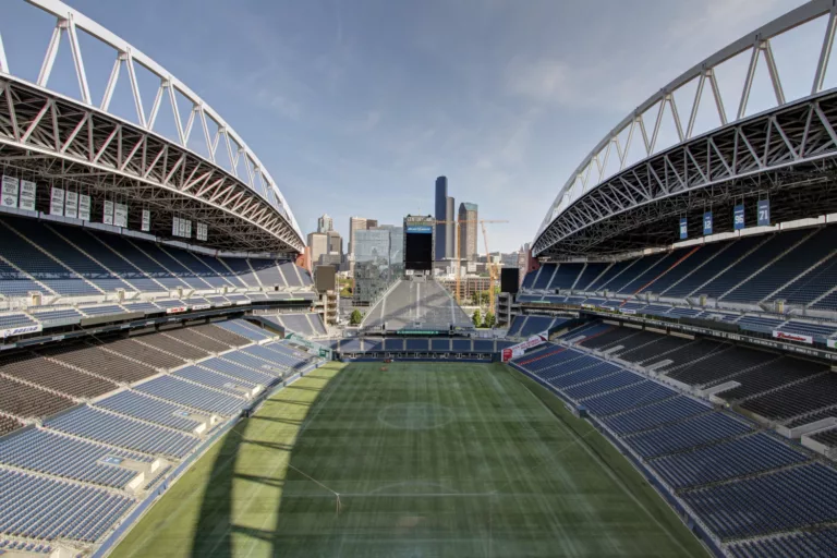 Daylight view of the seating bowl at Lumen Field, looking down on the field and the city's skyline beyond