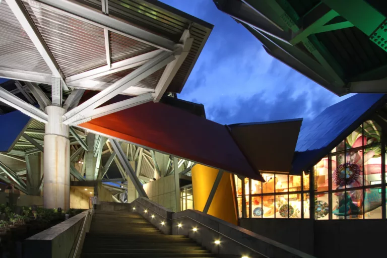 Looking up toward the Panama Museum of Biodiversity's front entry, illuminated at twilight