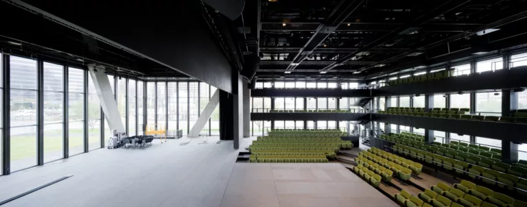 Interior view of the Dee and Charles Wyly Theatre's performance space with a three-level, L-shaped seating configuration
