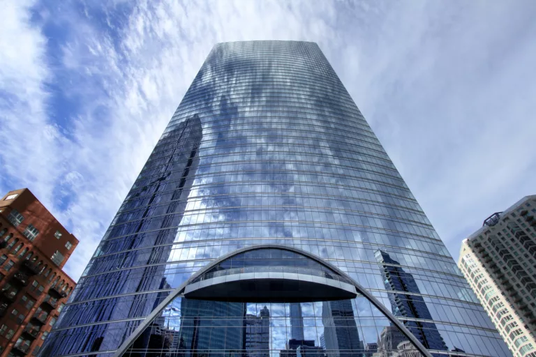 Exterior daylight view looking up at the 52-story River Point Tower's glass facade