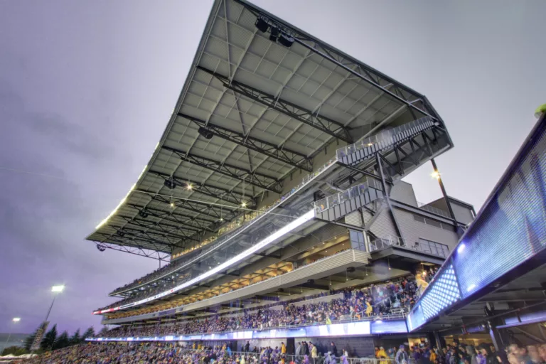 Exterior twilight view of the University of Washington’s open-air Husky Stadium and its towering south stands made of structural steel