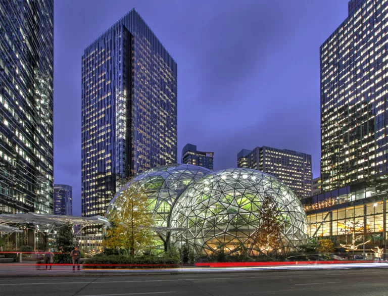 Exterior twilight view of Amazon in the Regrade’s Spheres and surrounding high-rise buildings