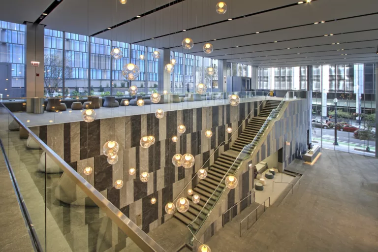 Interior daylight view of 151 North Franklin's two-story lobby with central staircase and public seating areas