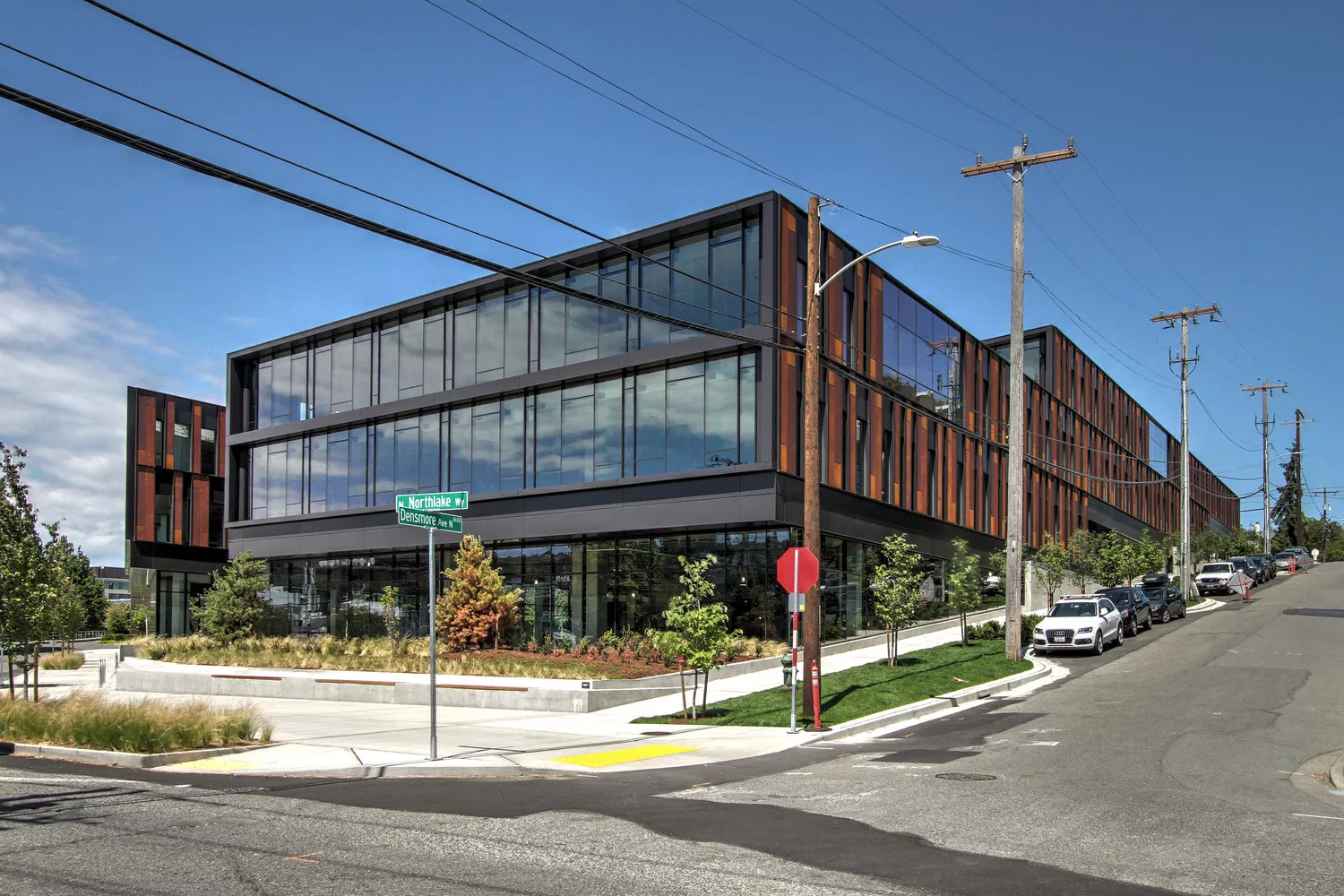 Exterior daylight view of the four-story NorthEdge office building situated on a sloping hillside