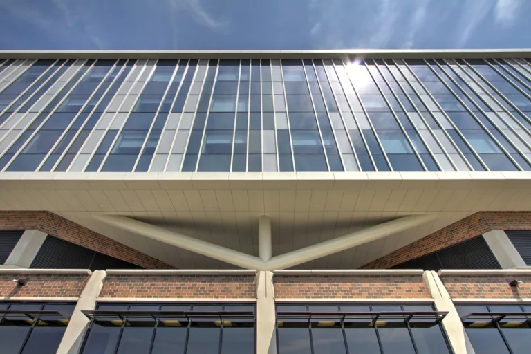 Exterior daylight view looking up at the queen post truss and five-story facade of the Advocate Good Samaritan Hospital Expansion