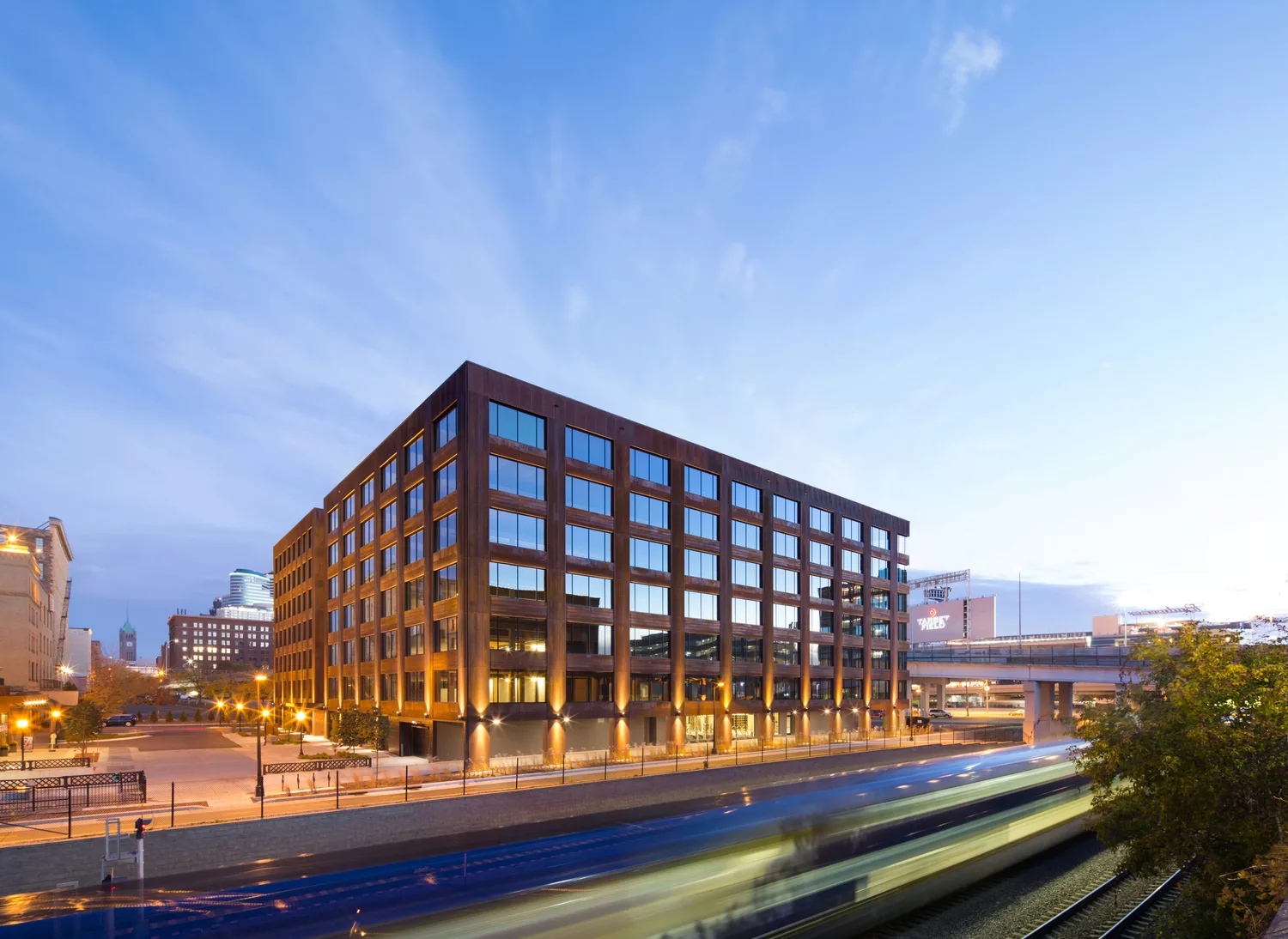 Exterior twilight view of the seven-story T3 Minneapolis, representing the first heavy-timber high-rise office building in the United States