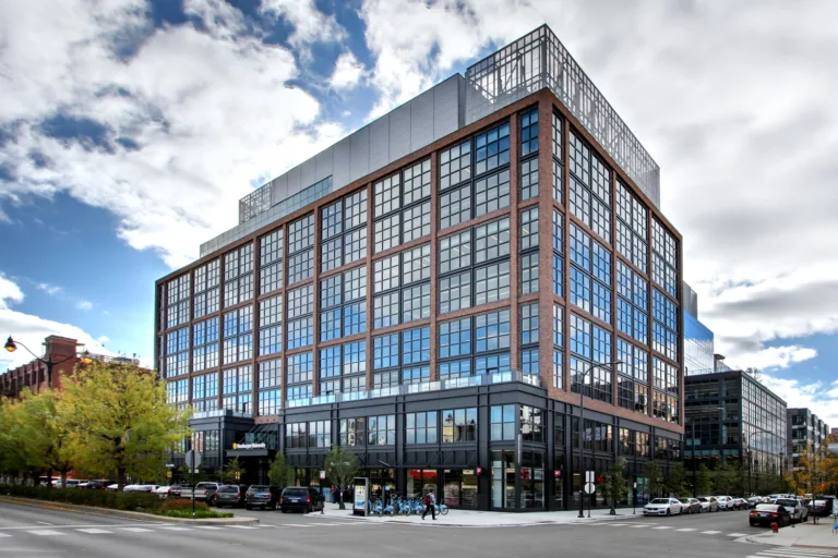 Exterior daylight view of the nine-story McDonald's Headquarters building with street-level retail and two expansive third-floor terraces