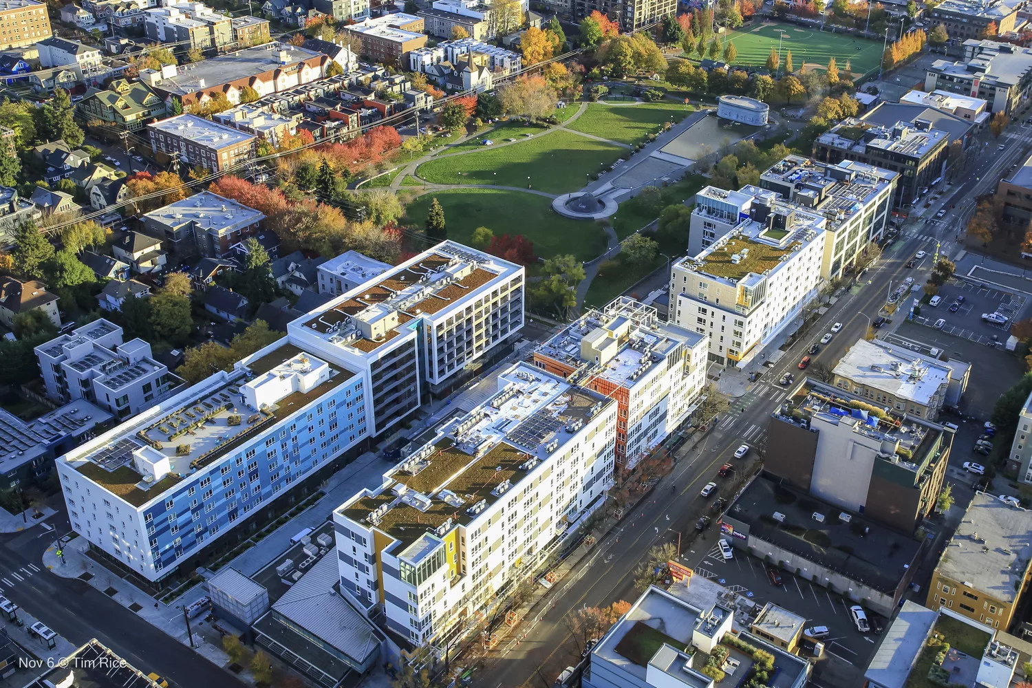 Aerial daylight view of Site A of Sound Transit's Capitol Hill transit-oriented development with Cal Anderson Park in the distance and surrounding low-rise residential and commercial buildings