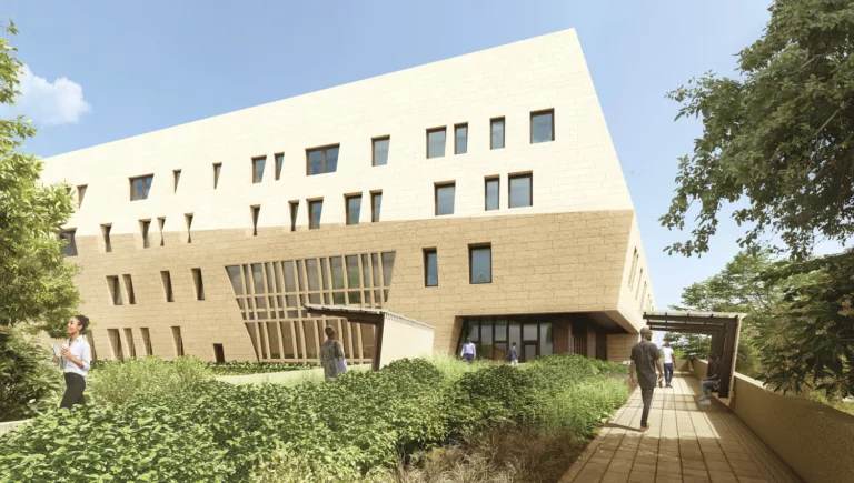 Exterior daylight rendering of the four-story, sandstone-colored U.S. Embassy in Juba featuring seven people gathered in the landscaped entry plaza with pathways and sheltered benches