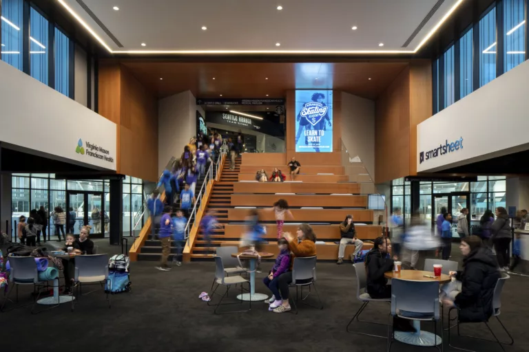 Interior view of the main entry and central staircase at the three-story Kraken Community Iceplex