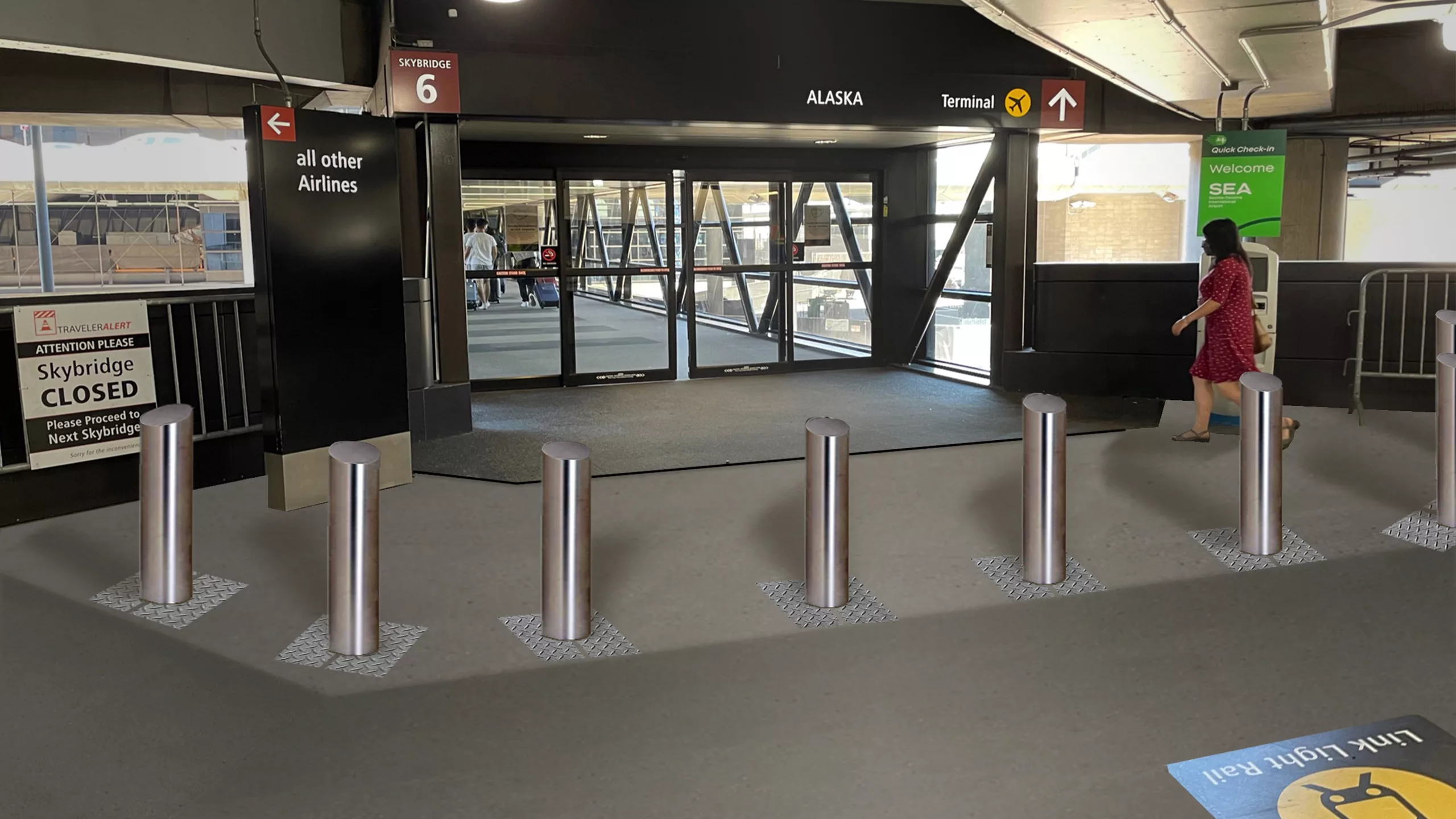 Daylight image of steel bollards in front of the pedestrian skybridge leading to Sea-Tac International Airport's main terminal