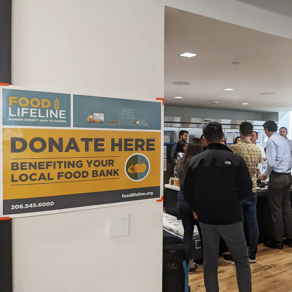 MKA staff gather in the company kitchen for a fundraising event for Food Lifeline