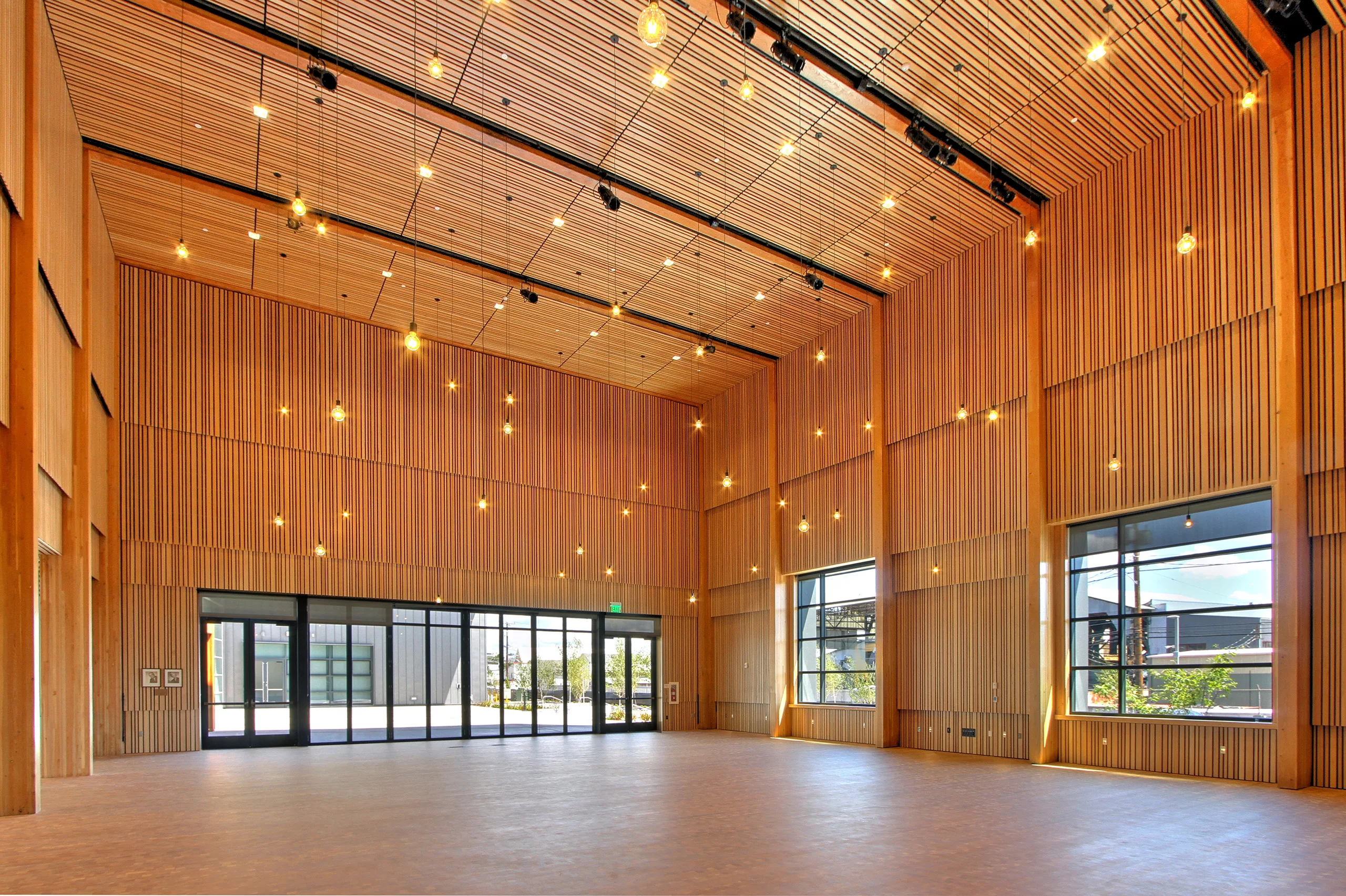 Interior view of the National Nordic Museum's auditorium with hanging lights and finished wood walls and ceiling